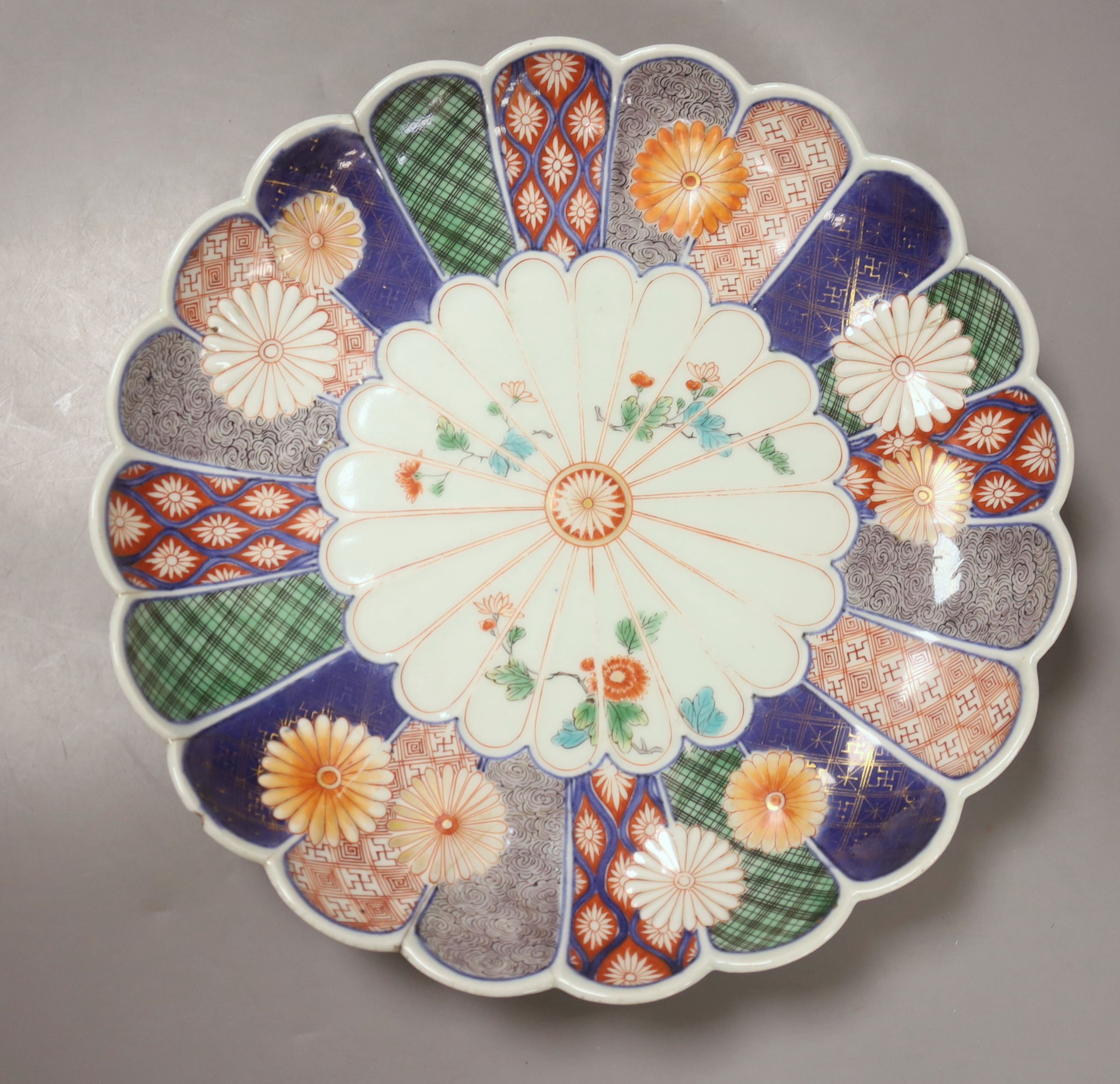 A Chinese Kangxi famille verte plate, decorated with a deer, a 19th century Chinese blue and white plate and an Imari scalloped dish, c.1850